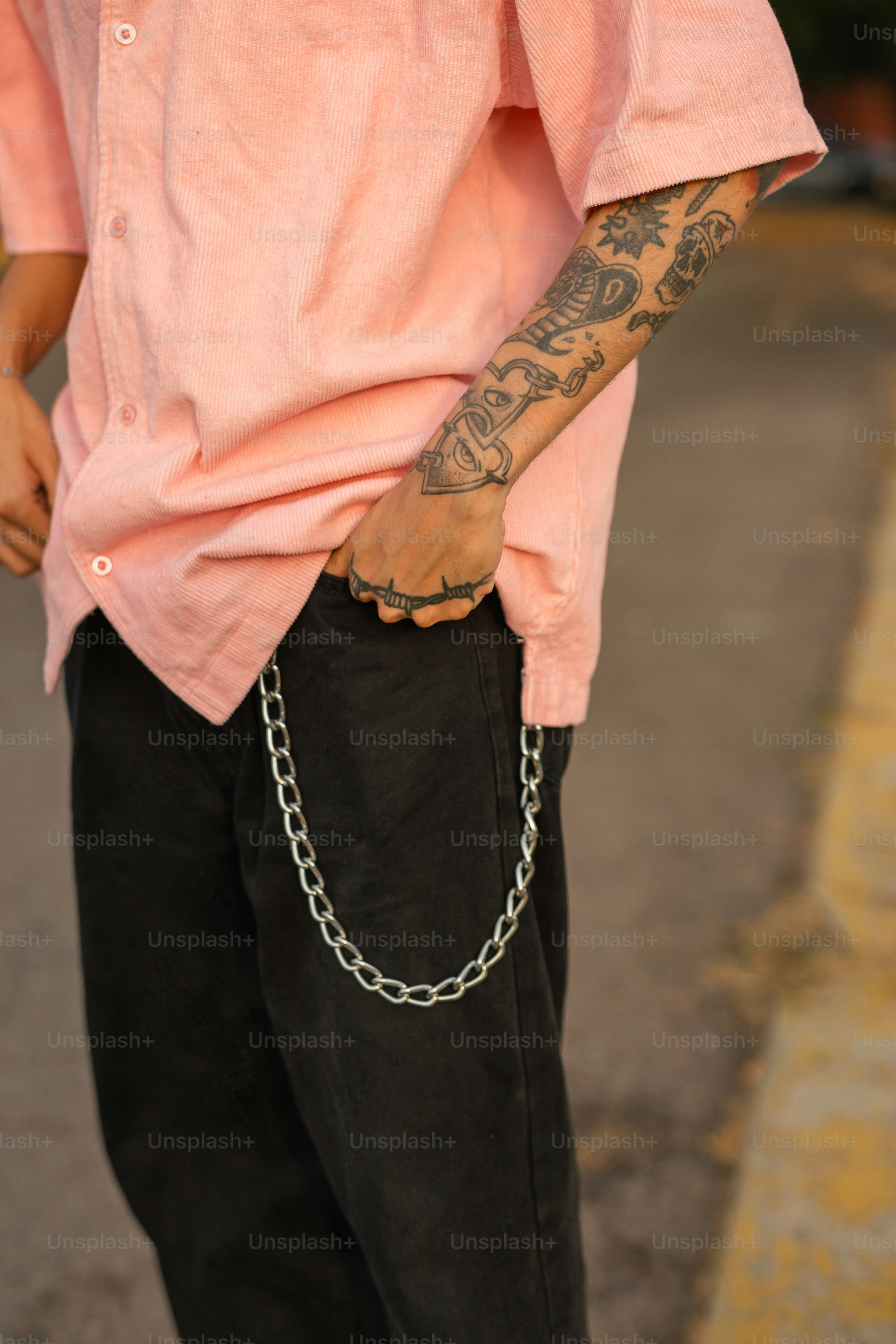 a man with a chain on his arm
